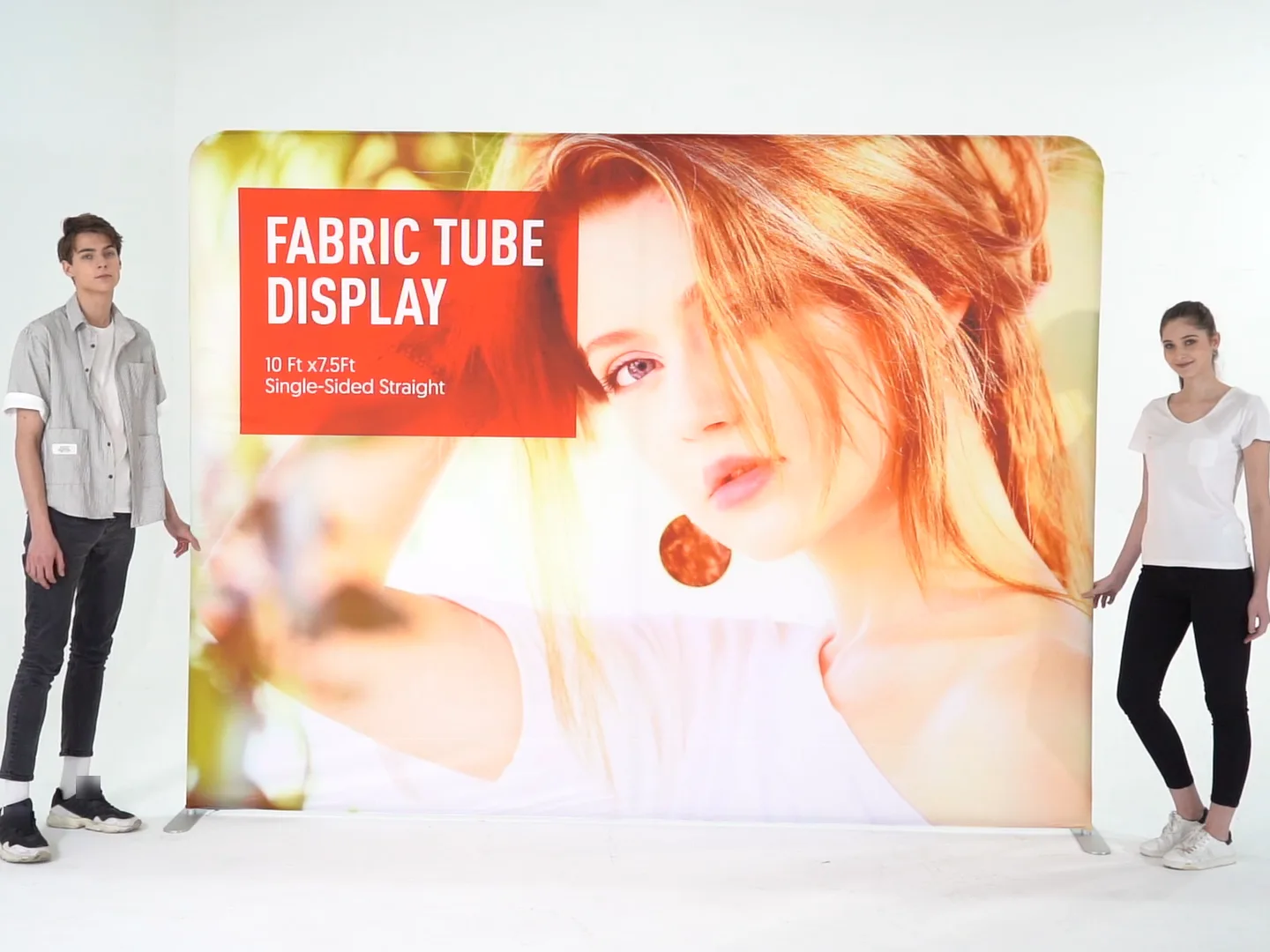 10 ft straight pillowcase tension fabric backdrop, set up, with two people for scale
