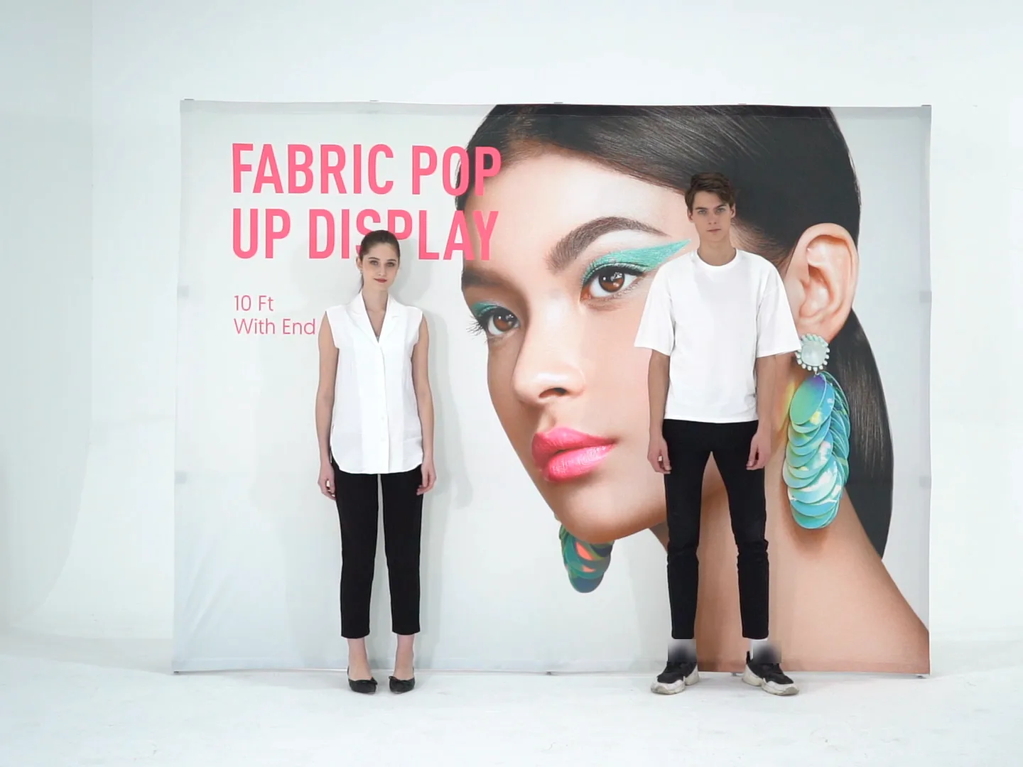10 ft straight fabric pop up display with end caps, set up, with two people for scale