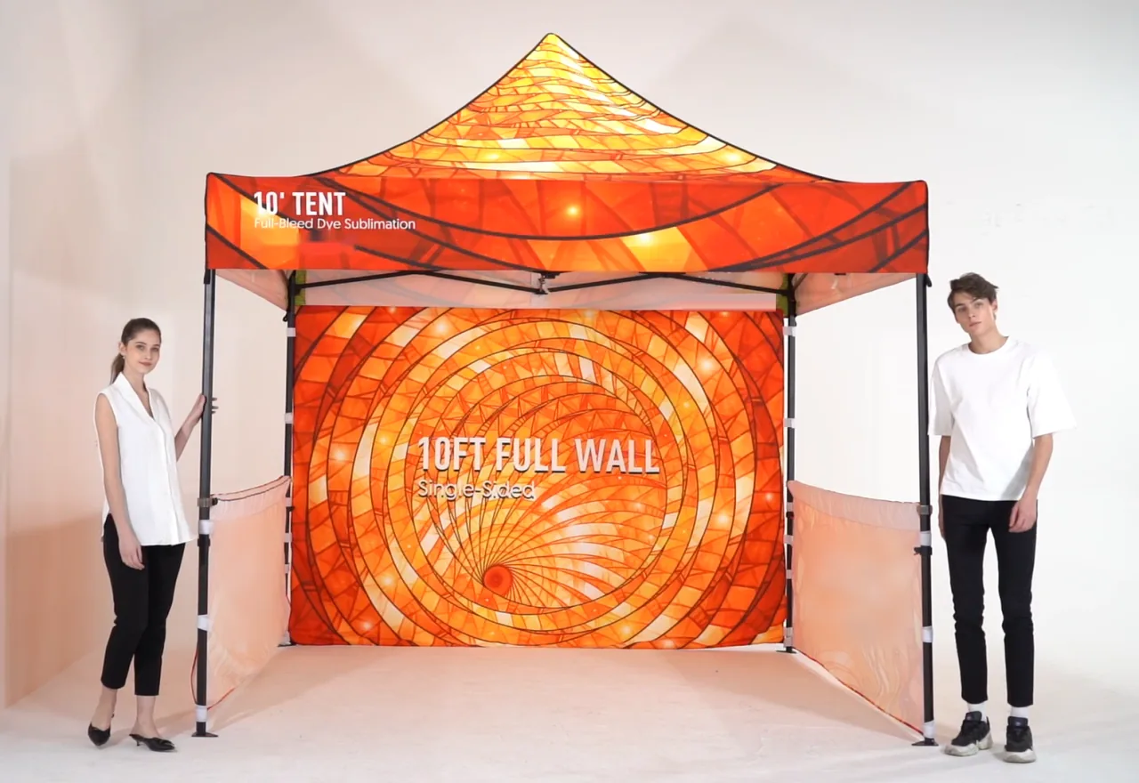 A custom printed 10 ft canopy tent with a printed back wall and half side walls, set up in a studio with two people for scale